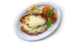Chicken Parmigiana with a small helping of spaghetti in marinara sauce 